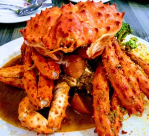 Two crabs piled high on a plate
