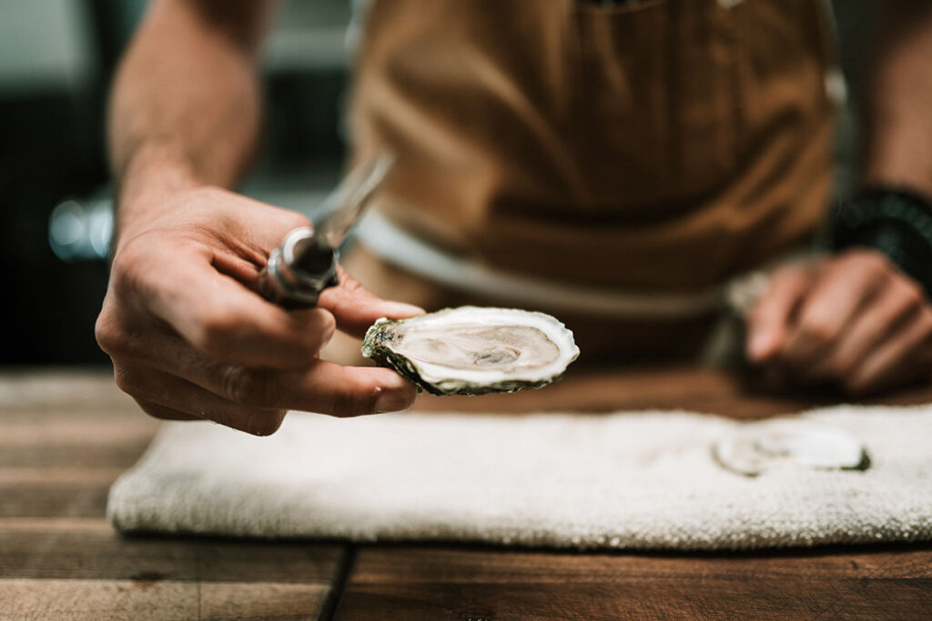 a person holding an oyster