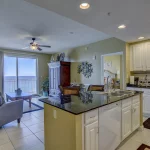 Bright kitchen with white cabinets and appliances and stone counters