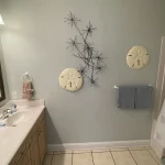 Bedroom with double sinks and shower