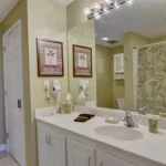 A bathroom with a large counter top and mirror