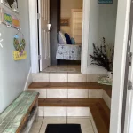 Entryway with stairs into a living room