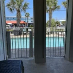 Doorway with safety fence leading into a hotel pool area