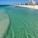 Ocean with beach and hotel on shoreline