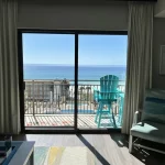 Balcony view from a hotel room of the beach and pool