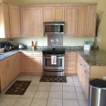 Kitchen with light wood cabinets and stainless steel appliances