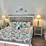 Guest room with nautical decorations and towel bird on bed