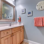 Bathroom sink counter and mirror with nautical decorations